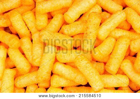 Cheese puff texture pattern background. Cheese puff snack snacks as background. Foog photo.