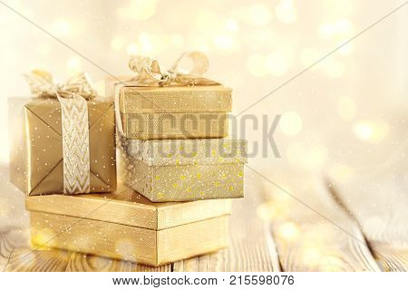 Arrangement of shiny bright boxes decorated with ribbons in glowing lights.
