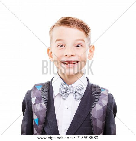Young cute primary school student fooling around. Young cute schoolboy showing teethless smile isolated on white background