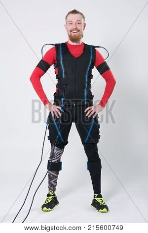 Red-haired Man With A Beard In Electric Muscular Suit For Stimulation