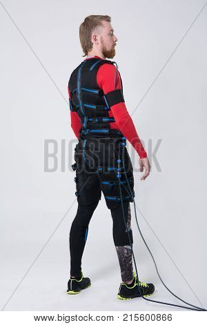 Red-haired Man With A Beard In Electric Muscular Suit For Stimulation
