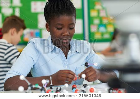 Female Pupil Using Molecular Model Kit In Science Lesson
