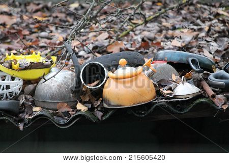 metal, teapots lay on the roof in autumn foliage ready for tea time