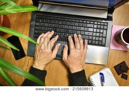 work at the Desk with a Cup of tea chocolate and herb for a laptop