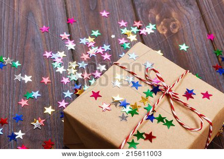 Simple christmas gift with red twine and decor stars.