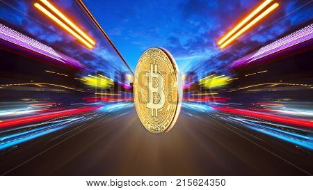 The physical coin is a gold bitcoin on a night road with speed traffic light trails abstract background. Concept Bitcion is speedy money.