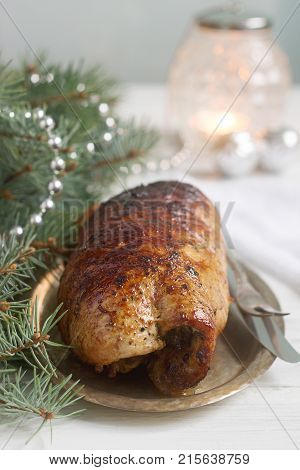 Baked Pork Roll Stuffed With Chard And Sundried Tomatoes In Christmas Or New Year's Decorations.
