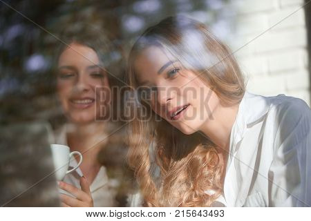 Shot of two young beautiful female friends using laptop together while studying at the local cafe friendship lifestyle people weekend leisure lifestyle urban technology communication browsing.