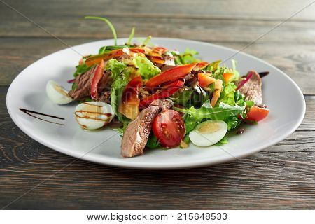 Close up shot of tasty fresh salad with grilled meat and eggs and sauce greens pepper delicious eating helthy nutrition lunch dinner supper cusine cooking recipe ingredients.