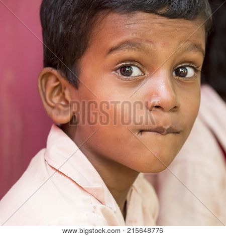 PONDICHERY PUDUCHERY INDIA - SEPTEMBER 04 2017. Unidentified boys girls children sit on the floor with their plate of rice and egg at the lunch time in the outdoor canteen of the school.