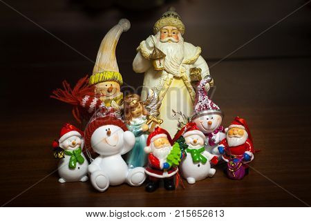 Winter day and evening or night. Christmas and New Year. In the frame of fairy-tale figures of a snowman a dwarf and Santa Claus. Horizontal frame. Soft focus. Photo taken in Ukraine Kiev