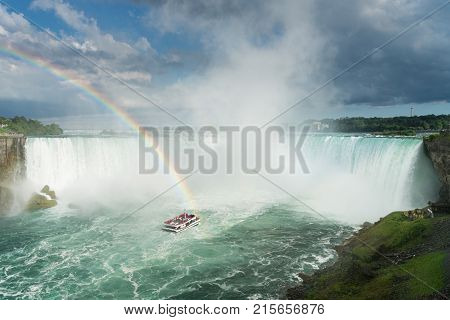 NIAGARA FALLS, CANADA - JUNE 28, 2016: Hornblower cruise boat takes tourists to Horseshoe waterfall on Canadian side of Niagara Falls