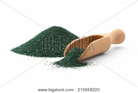 Wooden scoop and pile of spirulina powder on white background