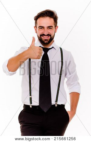 Handsome businessman showing thumb up on white background. Stylish guy dressed in white shirt and black trousers smiling looking at camera.