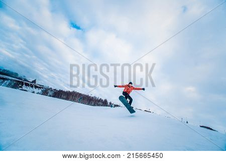 Snowboarder In A Black Helmet Riding On A Snowy Track.