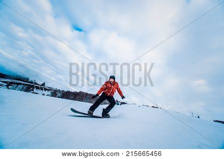 Snowboarder In A Black Helmet Riding On A Snowy Track.