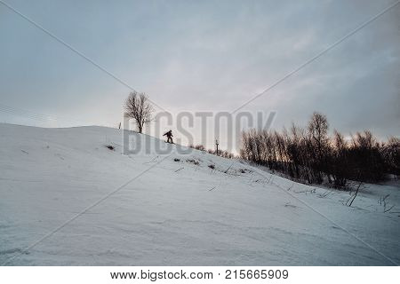 Snowboarder In A Black Helmet Riding On A Snowy Track.