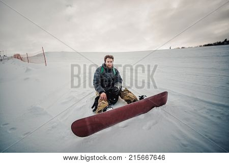 Snowboarder In A Black Helmet Riding On A Snowy Track.