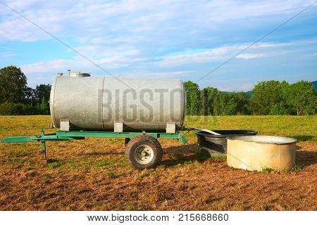 Water trough for drinking of cow cattle in the field Franche Comte France.