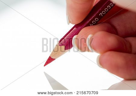 hand with red pencil
