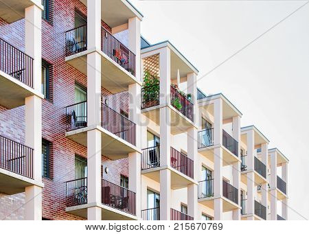 Fragment of complex of apartment buildings with balconies.