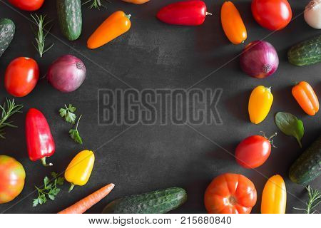 Fresh vegetables on a black chalkboard. Top view