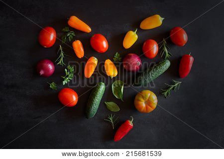 Fresh vegetables on a black chalkboard. Top view