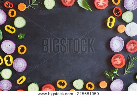 Fresh vegetables on a black chalkboard. Top view