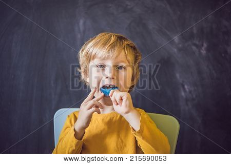 Three-year Old Boy Shows Myofunctional Trainer. Helps Equalize The Growing Teeth And Correct Bite, D