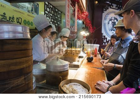 Shanghai, China - Nov 6, 2017: People buying Shanghai dumpling, also called xiaolongbao at a food stall. It is a type of popular traditional food in China.