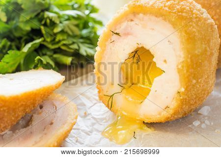 Chicken Kiev cutlets with parsley leaves and butter.