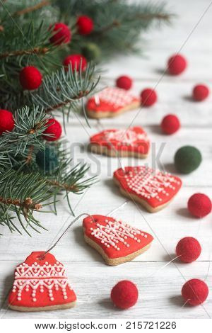 Gingerbread Bells, A Garland Of Faded Beads And Spruce Branches On A Light Background - A Christmas
