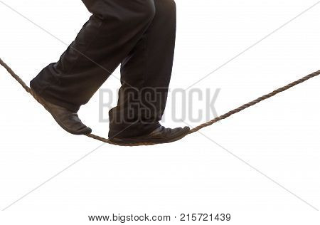 Tight rope walker's legs isolated. Feet of balancing on rope against white background