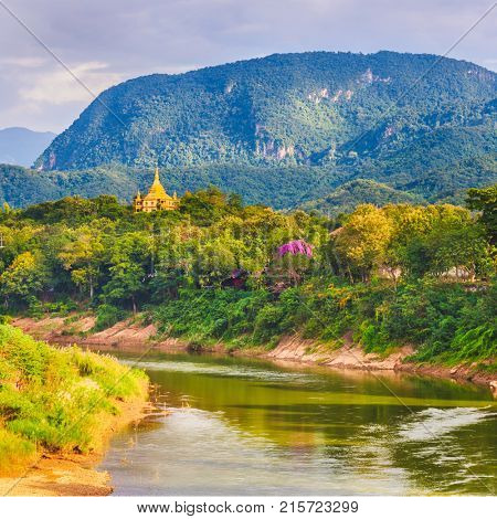 View of the river, temple and mountains. Beautiful landscape. Luang Prabang. Laos.