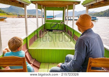 Tourists enjoy boat trip by Mekong river. Luang Prabang. Laos.