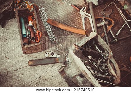 A toolbox with different instruments. A set of tools on a cement background.