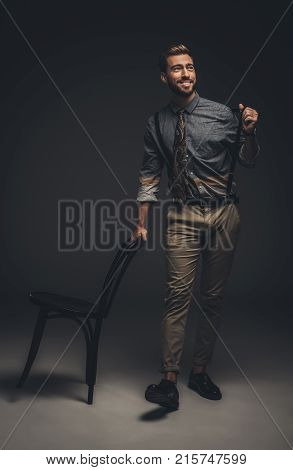 Man Leaning On Wooden Chair