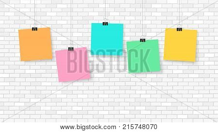 Posters on binder clips. Paper templates on brick wall. Realistic mock up. Empty notepad sheet for your business design. Brick wall. Vector templates for lettering quote images or logos.