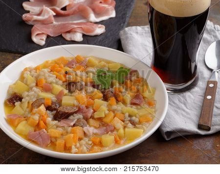 Traditional Irish dish Dublin coddle with sausages and beer on a table