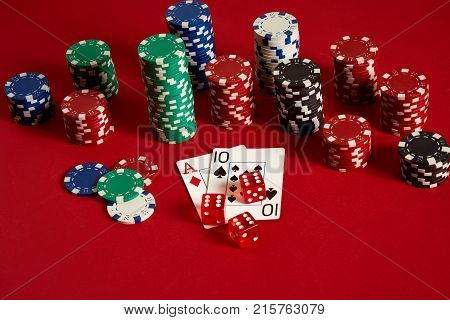 Poker cards and gambling chips on red background. Top view. Copy space. Still life. Flat lay. Cards - Ace and Ten