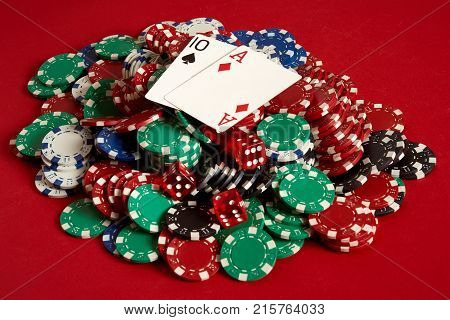 Poker cards and gambling chips on red background. Top view. Copy space. Still life. Flat lay. Cards - Ace and Ten