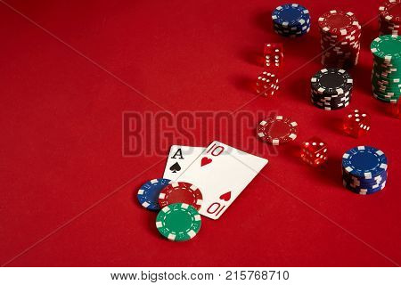 Poker cards and gambling chips on red background. Top view. Copy space. Still life. Flat lay. Cards - Ace and Ten