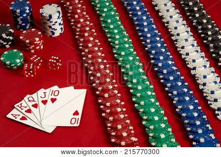 Poker cards and gambling chips on red background. Top view. Copy space. Still life. Flat lay. Royal flush