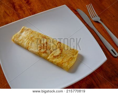 Classic omelet on the white plate. Fresh breakfast.