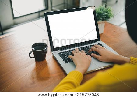 Business Technology Concepts - Digital lifestyle working outside office. Woman hands typing laptop computer with blank screen on table in coffee shop. Blank laptop screen mock up for display of design