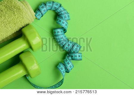 Tape Measure In Cyan Color Near Lightweight Barbells, Copy Space