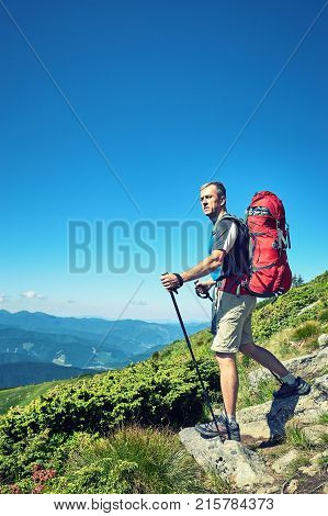 Hiking in the mountains with a backpack in the summer.