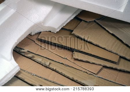Background Image With A Lot Of Beige Cardboard Paper And Styrofoam Boxes Disgarded As Rubbish. The C
