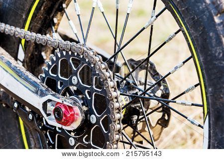 rear wheel motorcycle trial and enduro. Mounted on the wheel gear and chain with spokes. Close-up of the rear wheel of an off-road motorcycle