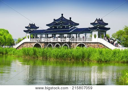 May 16 2015. Lake Tai China. Chinese tourists walking across the bridge of meeting fairy on Lake Tai or Taihu in Wuxi China in Jiangsu province.